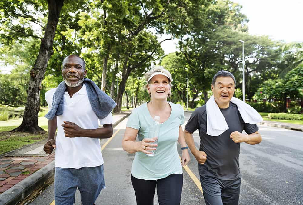 group senior friends jogging together park