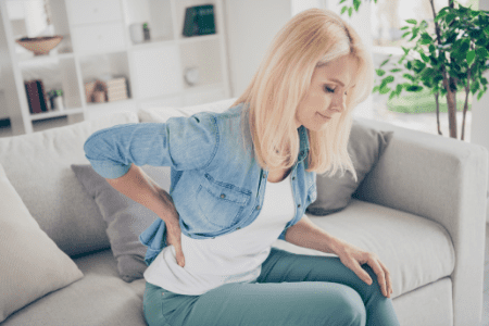 Woman struggling with arthritis in her lower back