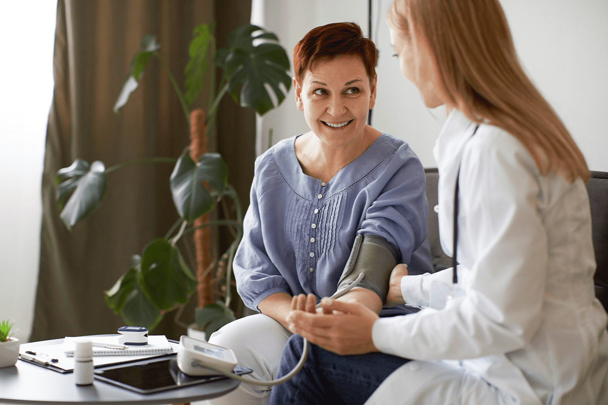 woman getting pressure taken by female medical professional