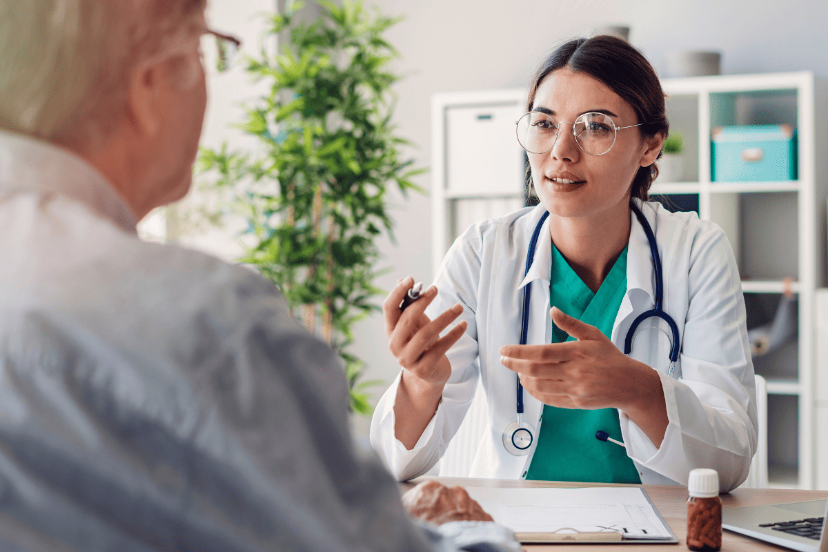 doctor consulting senior patient in clinical office