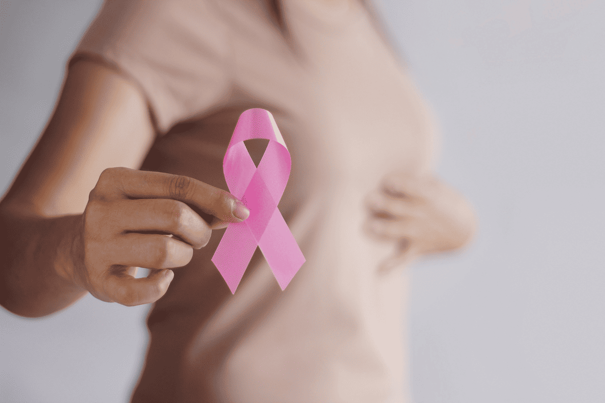Woman holding Breast Cancer Ribbon